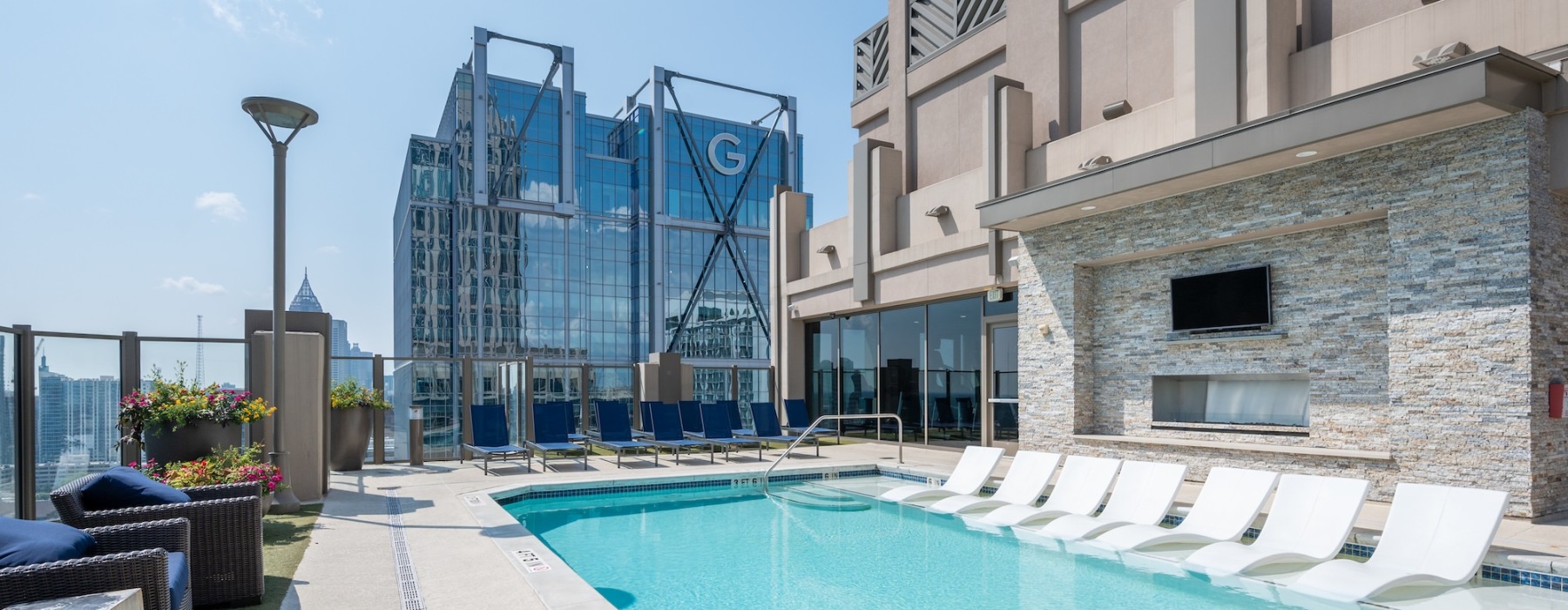 Resort-style swimming pool with lounge seating