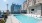 a pool with chairs around it