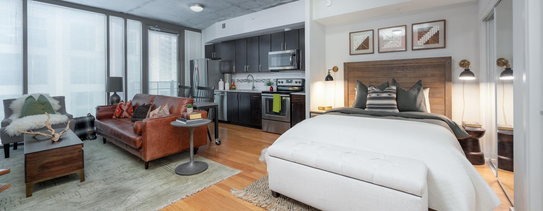 a bedroom with a bed and couches