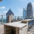 a patio with chairs and tables and a view of a city