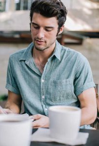 A Man Reading an Articles with Coffee